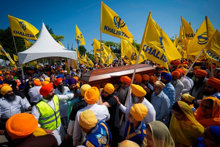 Mourners carry the casket of Sikh community leader Hardeep Singh Nijjar during a funeral procession in Surrey, Canada, in June 