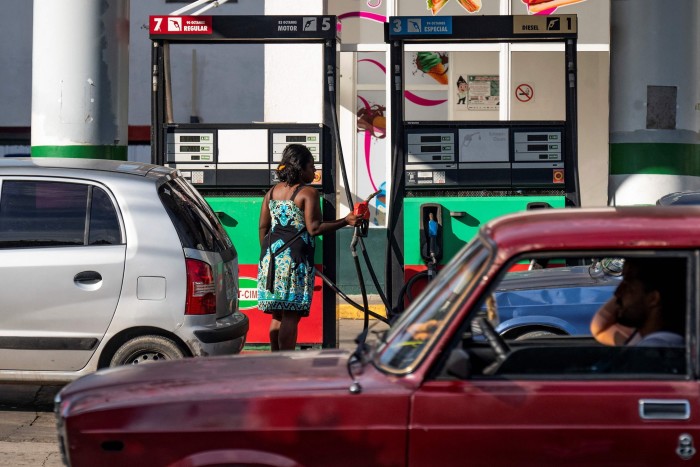 A driver fills a car with petrol in Havana