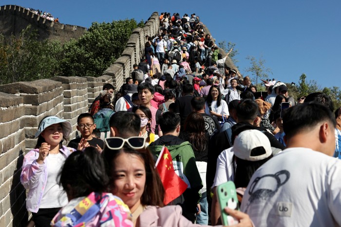 Visitors pose for pictures as they visit the Badaling section of the Great Wall of China