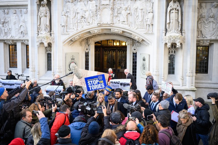 Protesters and journalists outside the Supreme Court after its Rwanda judgment last week