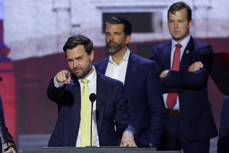 © Reuters. Republican vice presidential candidate J.D. Vance waves as Donald Trump Jr. joins him on stage during his walkout ahead of the second day of the Republican National Convention, at the Fiserv Forum in Milwaukee, Wisconsin, U.S., July 16, 2024. REUTERS/Mike Segar