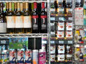 Beer cans are stacked as props in front of an ice cream display, during a news conference attended by Ontario Premier Doug Ford at a convenience store in Toronto on December 14, 2023.